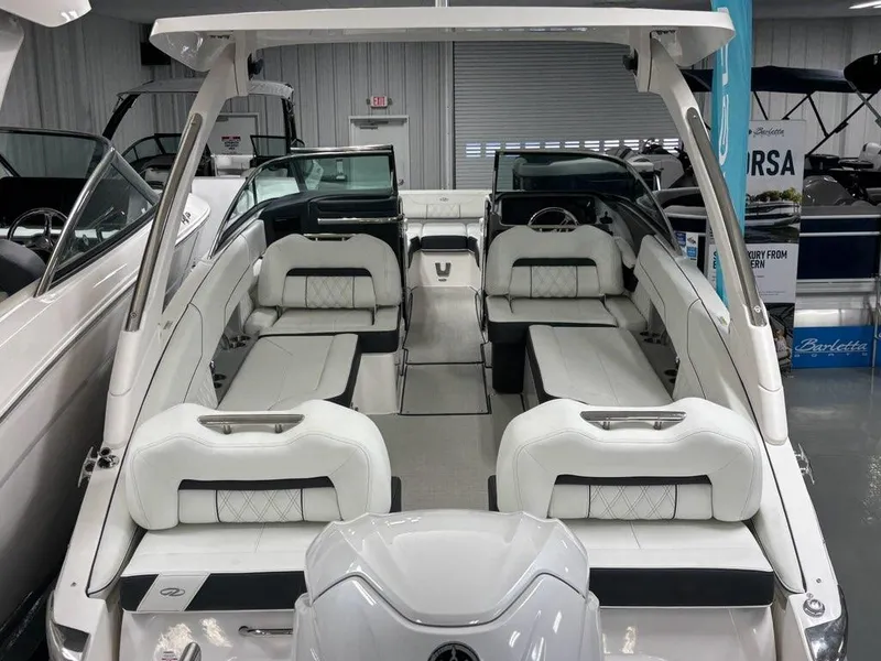 Slide: The Image of 2026 Regal LX6 boat interior with white seating and modern design in showroom. - 29