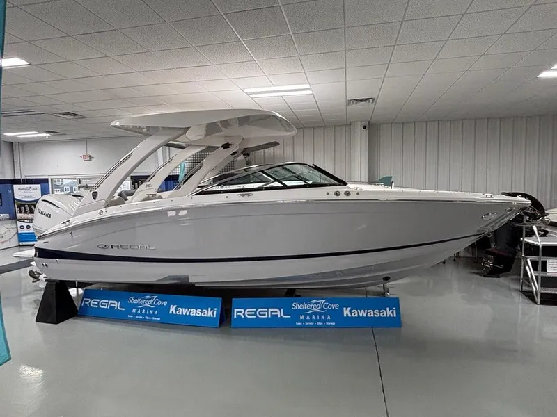 Slide: The Image of 2026 Regal LX6 boat displayed indoors at Sheltered Cove Marina. - 7