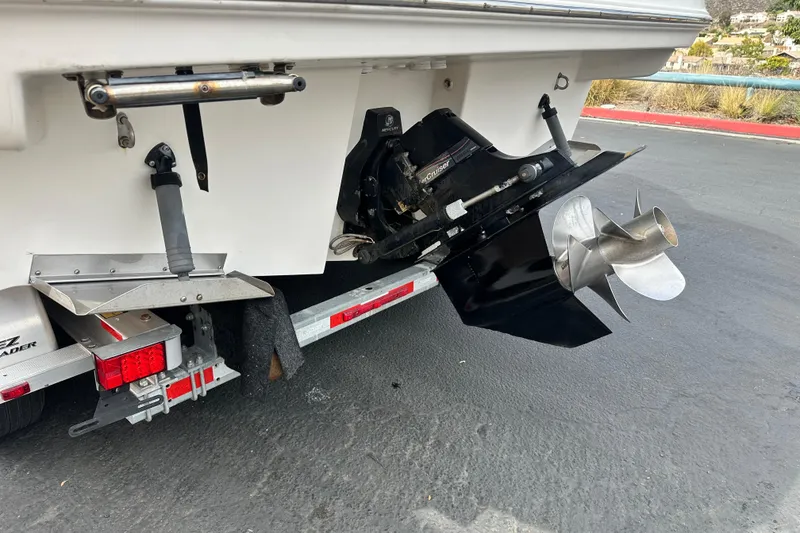 Slide: The Image of 2012 Bayliner 285 Cruiser interior seating area with white upholstery and cup holders. - 12