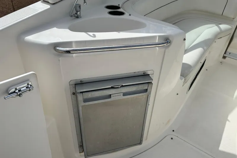 Slide: The Image of 2012 Bayliner 285 Cruiser interior with white seating and storage compartments. - 15