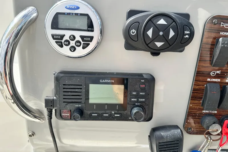 Slide: The Image of Interior of 2012 Bayliner 285 Cruiser with kitchenette, seating, and striped bed. - 22