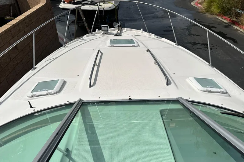 Slide: The Image of Compact kitchen area in a 2012 Bayliner 285 Cruiser with stove, microwave, and sink. - 24