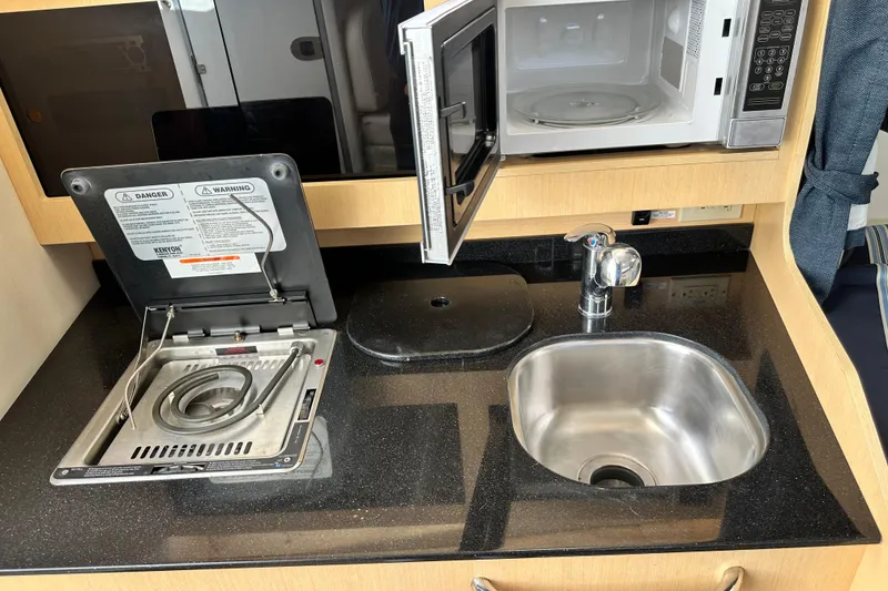 Slide: The Image of 2012 Bayliner 285 Cruiser bathroom with sink, toilet, and porthole window. - 28