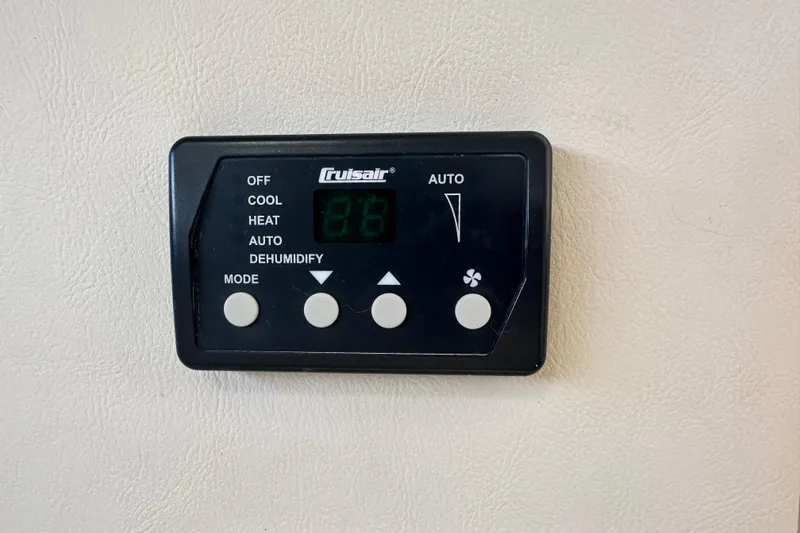 Slide: The Image of Interior of 2012 Bayliner 285 Cruiser with striped bedding and table setup. - 31