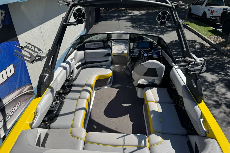 Slide: The Image of 2017 Malibu Wakesetter 23 LSV interior with gray and yellow seating, advanced dashboard, and speakers. - 11