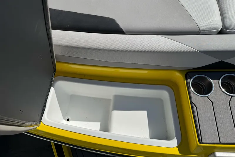 Slide: The Image of 2017 Malibu Wakesetter 23 LSV interior with storage compartment and cup holders. - 13