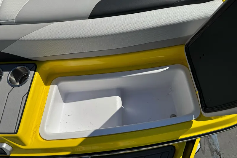 Slide: The Image of 2017 Malibu Wakesetter 23 LSV interior storage compartment with cup holders and cushioned seating. - 14