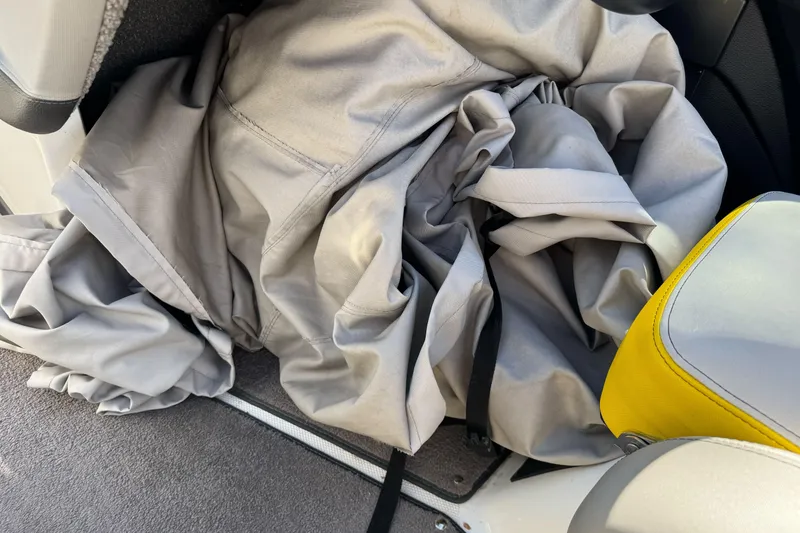 Slide: The Image of Gray boat cover inside 2017 Malibu Wakesetter 23 LSV, next to yellow seat. - 17