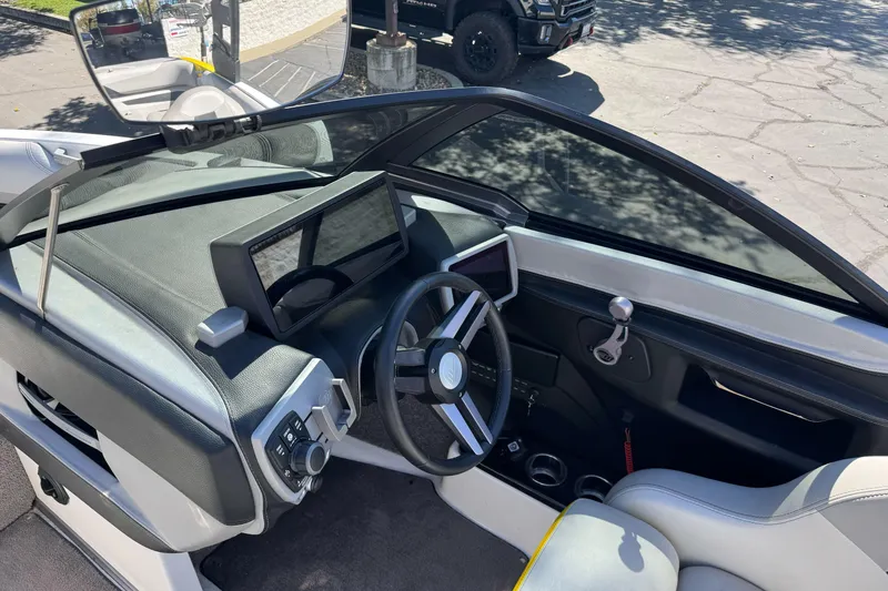 Slide: The Image of 2017 Malibu Wakesetter 23 LSV boat dashboard with steering wheel and controls. - 18