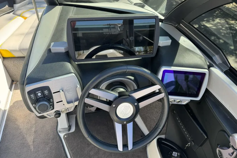 Slide: The Image of 2017 Malibu Wakesetter 23 LSV dashboard with steering wheel and digital displays. - 19