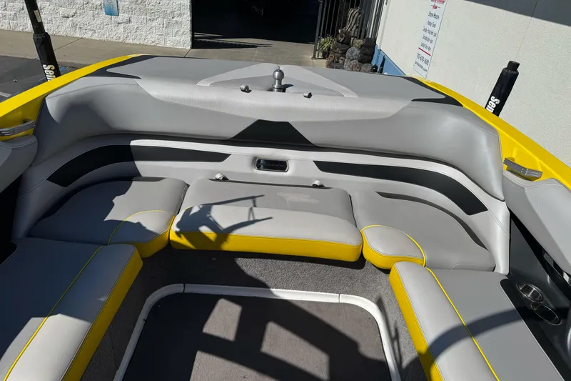 Slide: The Image of 2017 Malibu Wakesetter 23 LSV interior with gray and yellow seating, showcasing spacious design. - 27