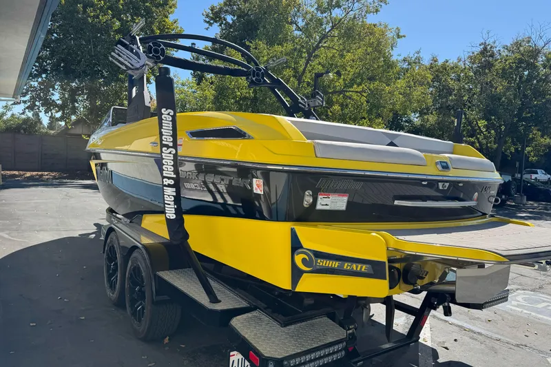 Slide: The Image of 2017 Malibu Wakesetter 23 LSV boat in vibrant yellow, parked on a trailer. - 3