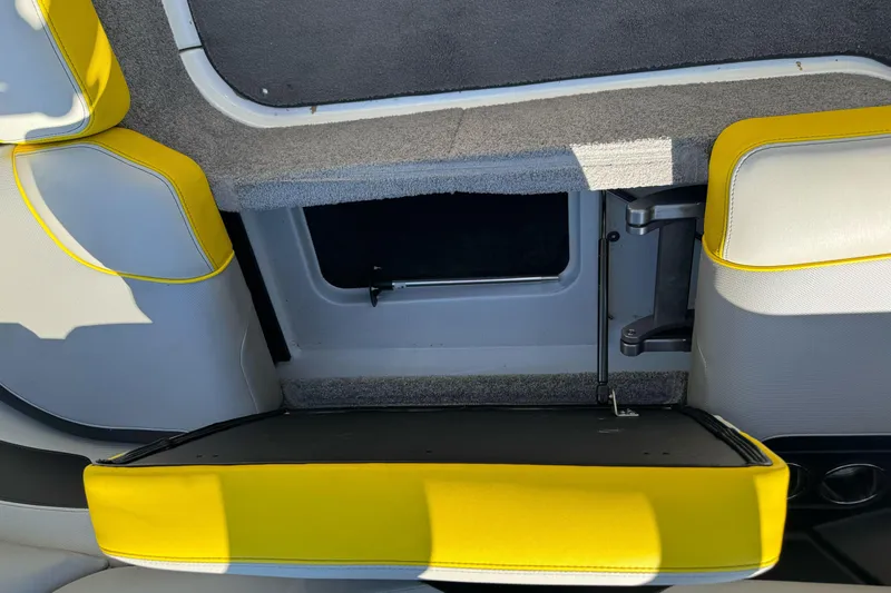 Slide: The Image of 2017 Malibu Wakesetter 23 LSV interior storage compartment with yellow and gray upholstery. - 31