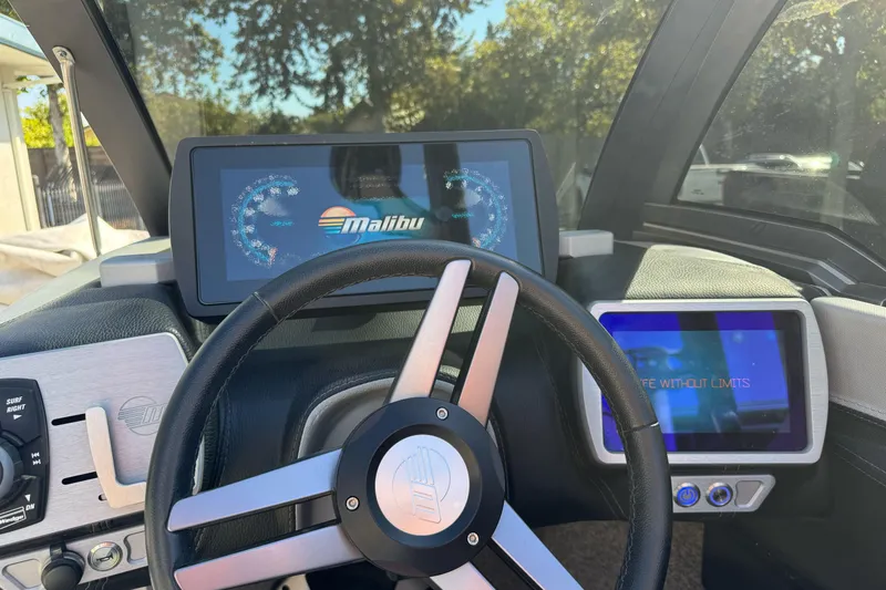Slide: The Image of 2017 Malibu Wakesetter 23 LSV dashboard with steering wheel and digital displays. - 35