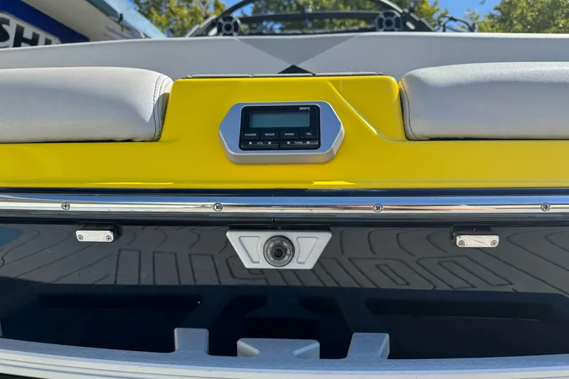 Slide: The Image of 2017 Malibu Wakesetter 23 LSV boat dashboard with yellow accents and control panel. - 4
