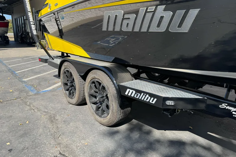 Slide: The Image of 2017 Malibu Wakesetter 23 LSV boat on trailer, black and yellow design. - 6