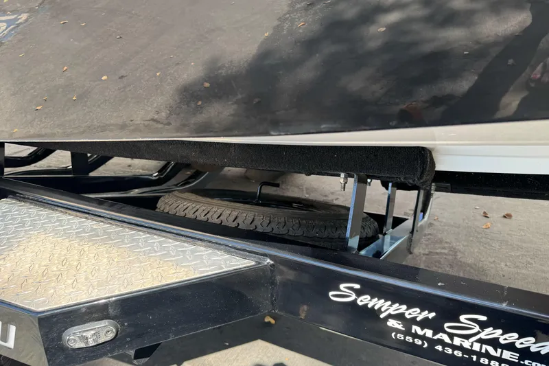 Slide: The Image of 2017 Malibu Wakesetter 23 LSV trailer with spare tire and custom marine branding. - 7