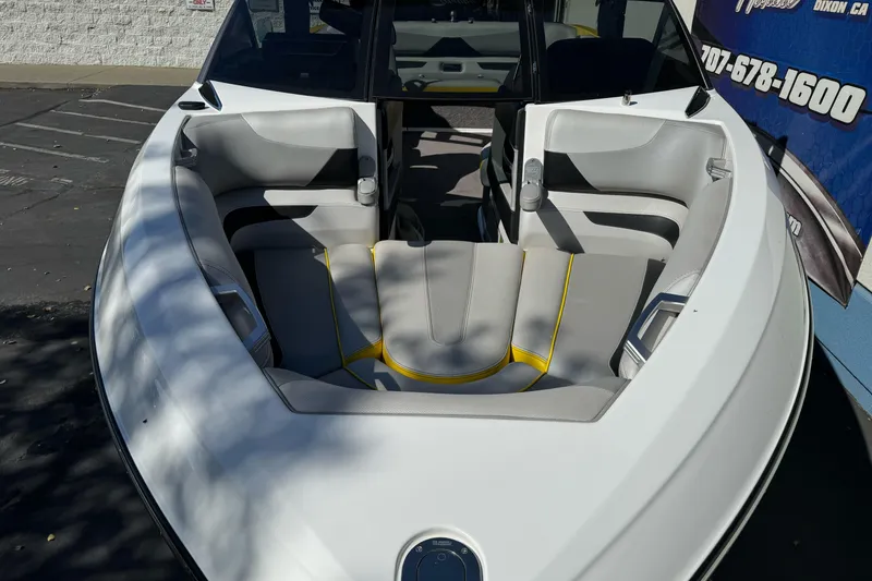 Slide: The Image of 2017 Malibu Wakesetter 23 LSV boat interior with gray and yellow seating. - 9