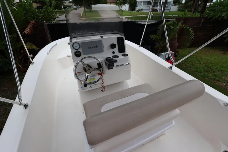 Slide: The Image of 2016 Robalo R160 Center Console boat with Garmin navigation system, parked outdoors. - 1