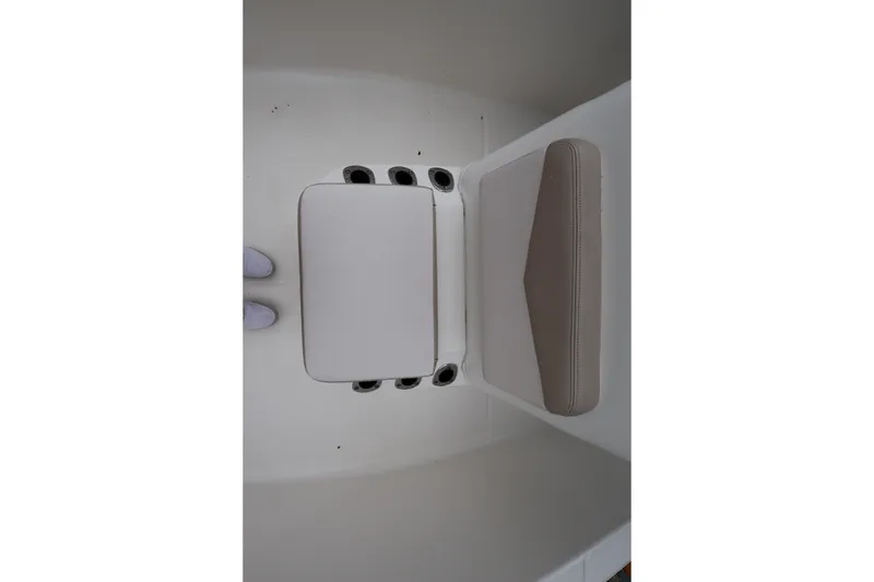 Slide: The Image of 2016 Robalo R160 Center Console boat seating area with rod holders. - 13