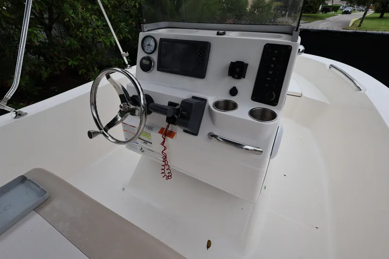 Slide: The Image of 2016 Robalo R160 Center Console boat interior with steering wheel and control panel. - 18