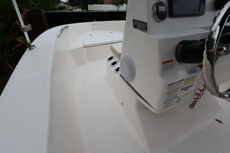 Slide: The Image of 2016 Robalo R160 Center Console boat interior with steering wheel and control panel. - 19