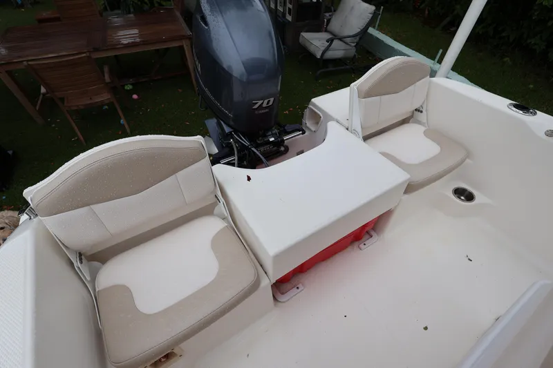 Slide: The Image of 2016 Robalo R160 Center Console boat interior with seating and Yamaha 70 outboard motor. - 24