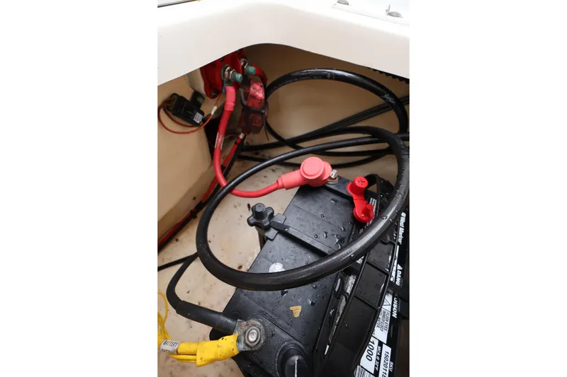 Slide: The Image of Battery compartment of 2016 Robalo R160 Center Console boat with cables and connectors. - 28