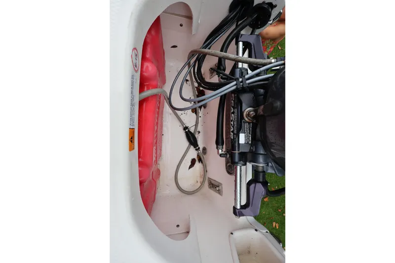Slide: The Image of 2016 Robalo R160 Center Console boat engine compartment with cables and hydraulic system. - 29