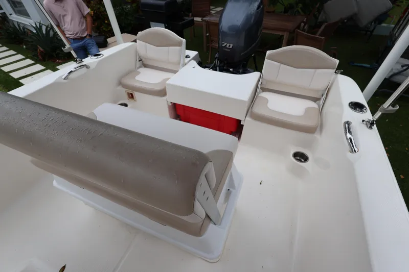 Slide: The Image of 2016 Robalo R160 Center Console boat interior with seating and engine view. - 32