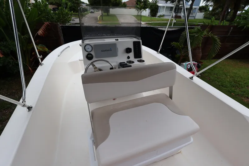Slide: The Image of 2016 Robalo R160 Center Console boat with Garmin navigation system, parked outdoors. - 34
