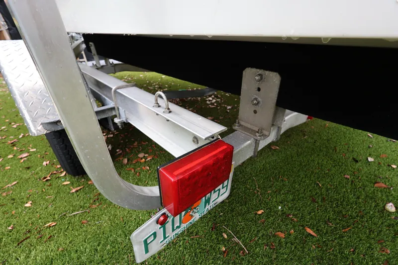Slide: The Image of Trailer of 2016 Robalo R160 Center Console boat on grass with license plate. - 37