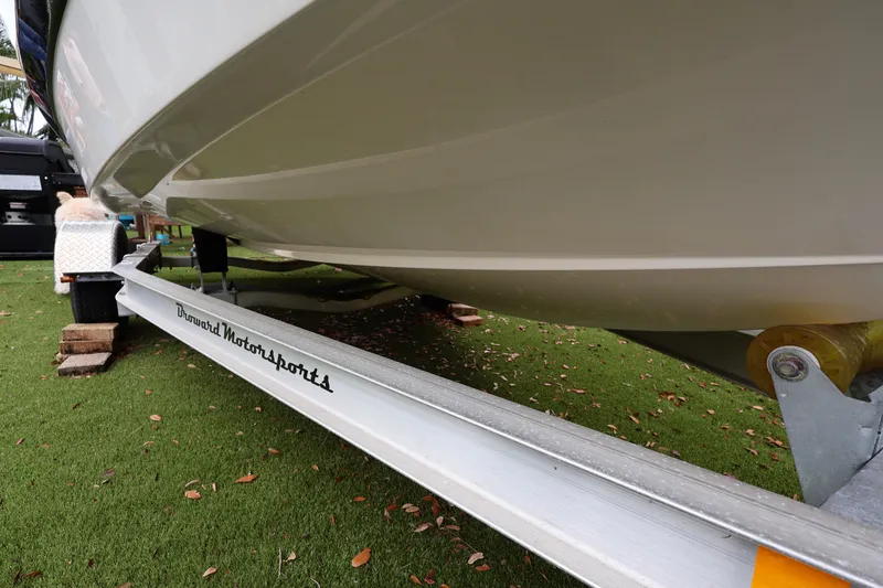 Slide: The Image of 2016 Robalo R160 Center Console boat on trailer, parked on grass. - 39