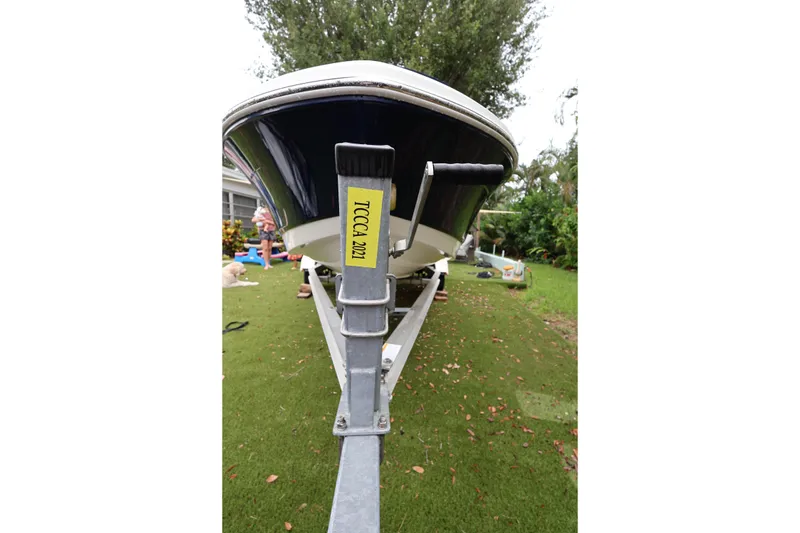 Slide: The Image of 2016 Robalo R160 Center Console boat on trailer, parked on grass. - 40