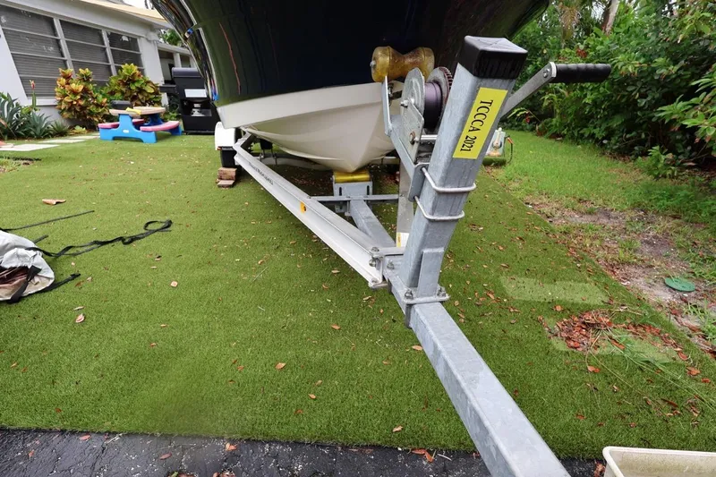 Slide: The Image of 2016 Robalo R160 Center Console boat on trailer in a grassy yard. - 42