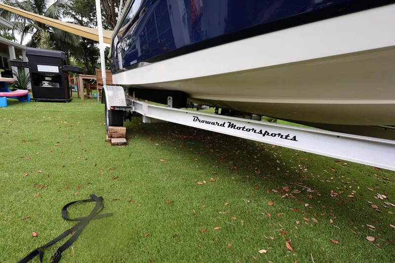 Slide: The Image of 2016 Robalo R160 Center Console boat on trailer, parked on grass. - 43