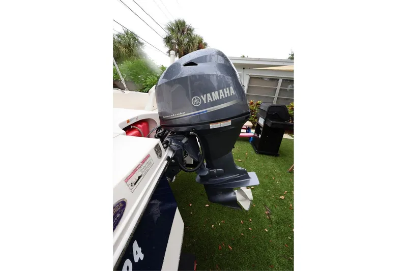 Slide: The Image of 2016 Robalo R160 Center Console with Yamaha outboard motor in a garden setting. - 47
