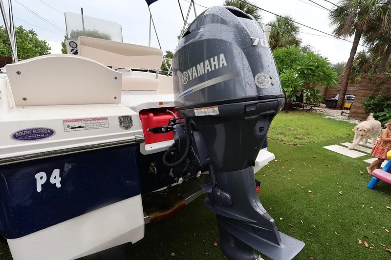 Slide: The Image of 2016 Robalo R160 Center Console with Yamaha outboard motor on grassy area. - 48