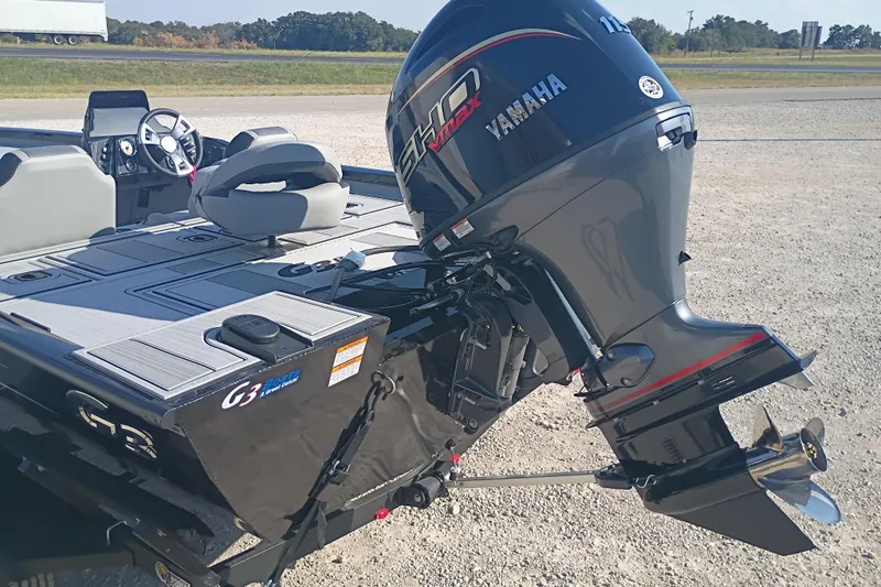 Slide: The Image of 2026 G3 1810SE boat with Yamaha outboard motor, parked on gravel. - 13