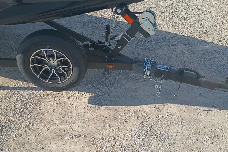 Slide: The Image of Trailer hitch and wheel of 2026 G3 1810SE on gravel surface. - 6