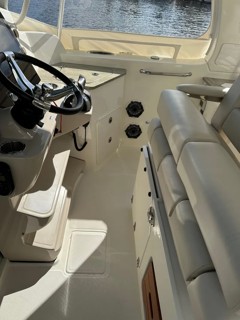Slide: The Image of 2020 Boston Whaler 350 Realm interior with steering wheel and seating, showcasing luxury design. - 38