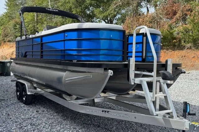 Slide: The Image of 2026 Veranda VV22RC pontoon boat on trailer, blue exterior, parked on gravel. - 2