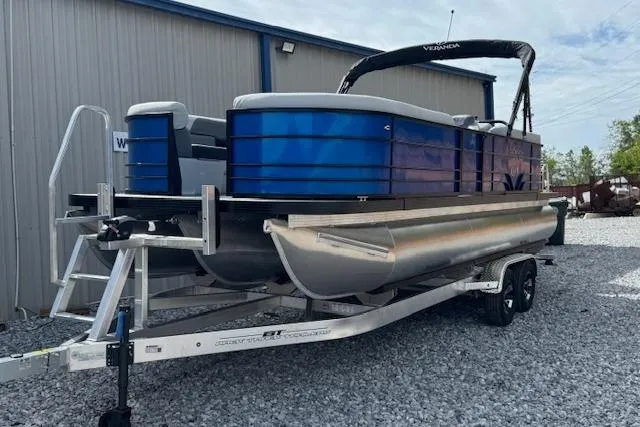 Slide: The Image of 2026 Veranda VV22RC pontoon boat on trailer, parked on gravel near a building. - 4