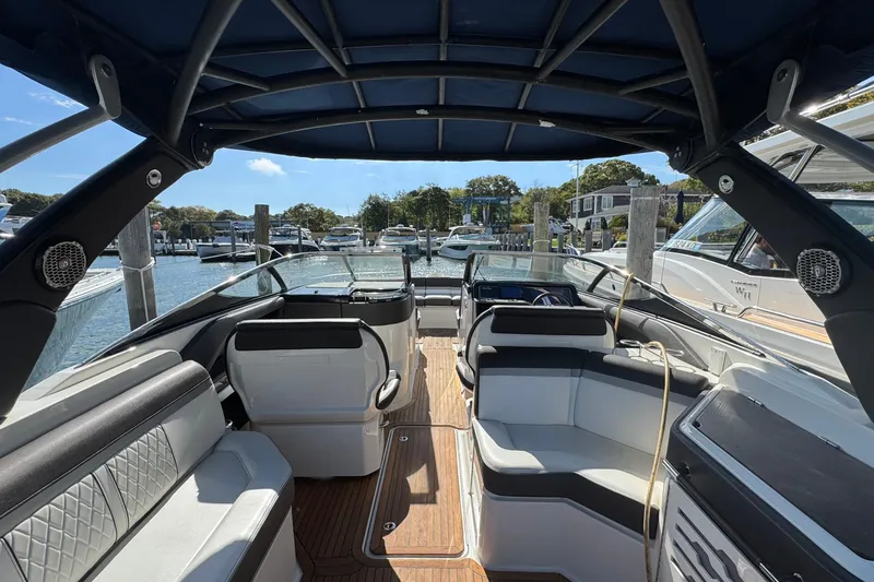 Slide: The Image of 2017 Sea Ray SLX 310 Outboard interior with luxurious seating and modern design at a marina. - 13