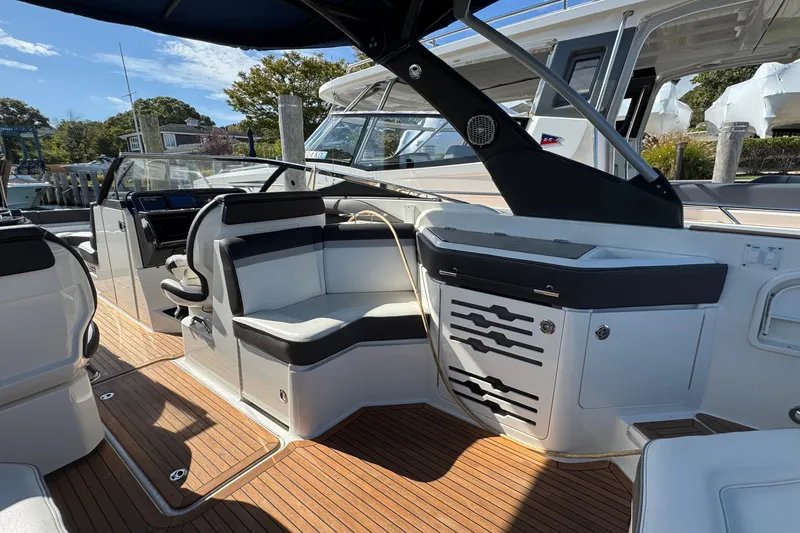 Slide: The Image of 2017 Sea Ray SLX 310 Outboard interior with sleek seating and modern design. - 14