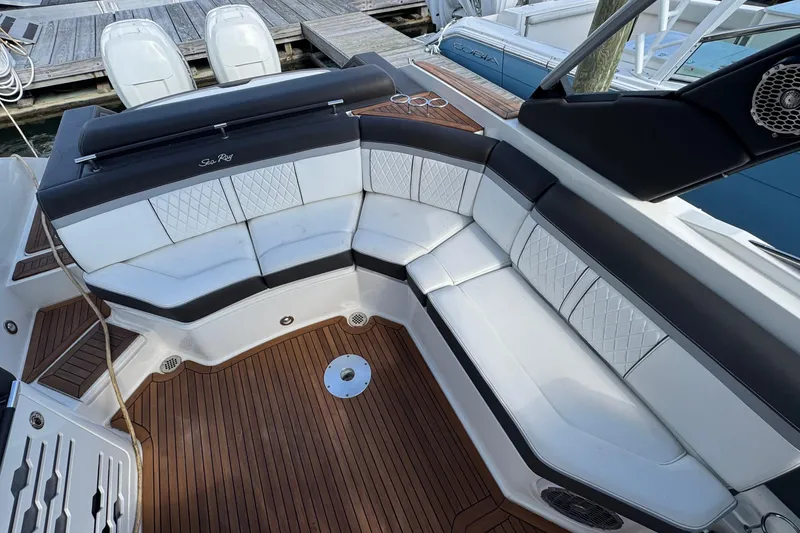 Slide: The Image of Luxurious seating on 2017 Sea Ray SLX 310 Outboard boat with elegant design and wood flooring. - 16