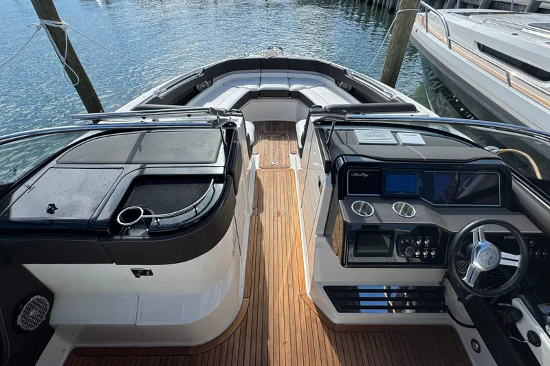 Slide: The Image of 2017 Sea Ray SLX 310 Outboard boat interior with sleek dashboard and seating. - 19