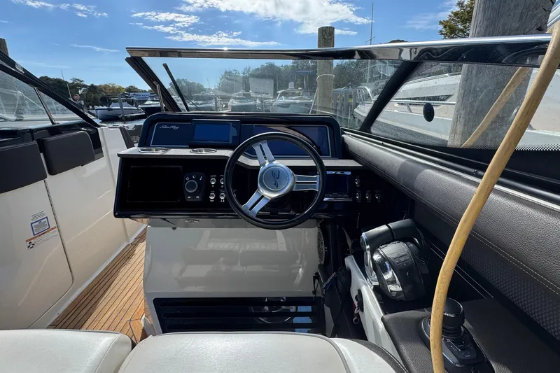 Slide: The Image of 2017 Sea Ray SLX 310 Outboard helm with steering wheel and control panel. - 22