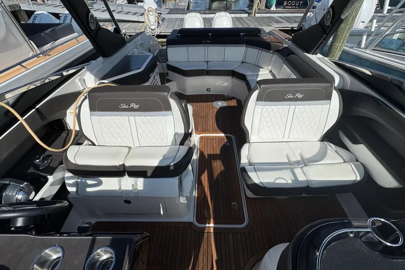 Slide: The Image of 2017 Sea Ray SLX 310 Outboard interior with luxurious seating and wood flooring. - 23