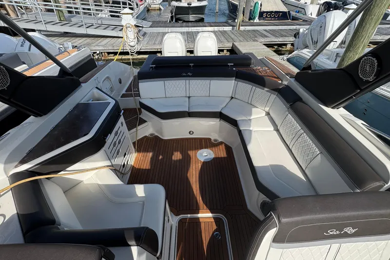 Slide: The Image of Luxurious 2017 Sea Ray SLX 310 Outboard boat interior with elegant seating and wood flooring. - 24